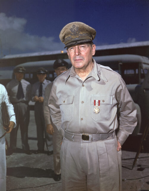 Douglas MacArthur standing with others outside