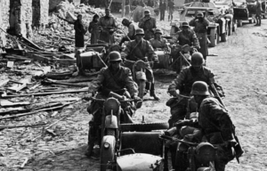 German soldiers sitting on parked motorcycles