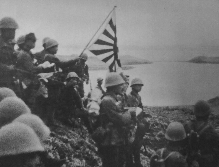 Japanese troops raising the Japanese flag on Kiska Island