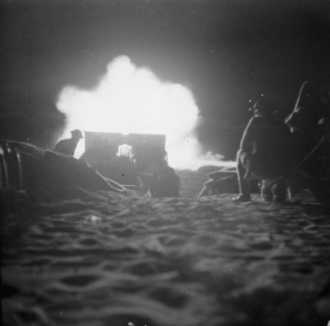 British troops launching a nighttime artillery barrage in the desert