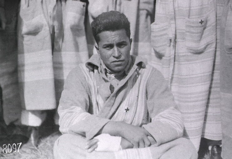 Cherokee soldier sitting with his arm bandaged