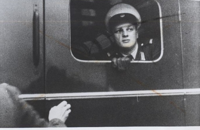 Conrad Schumann sitting in the back of a police van