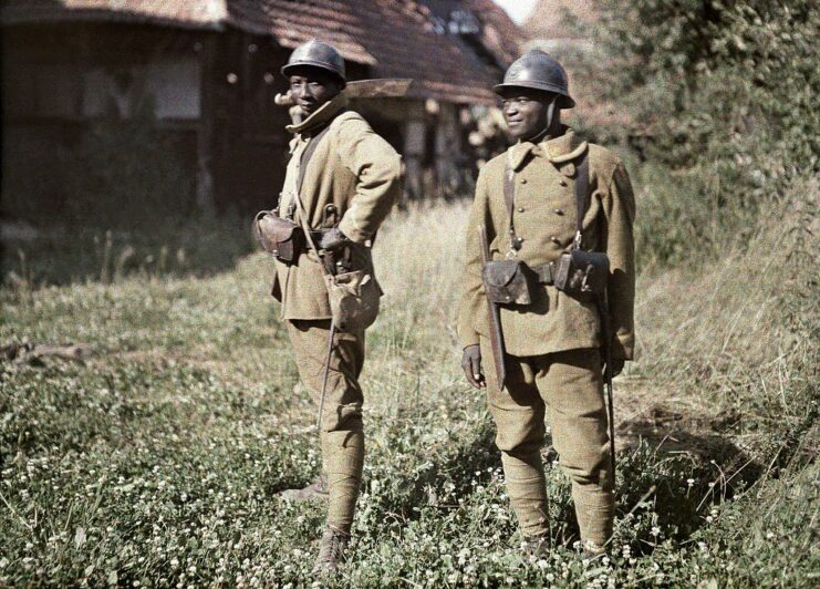 Two Senegalese soldiers standing outside in their military uniforms