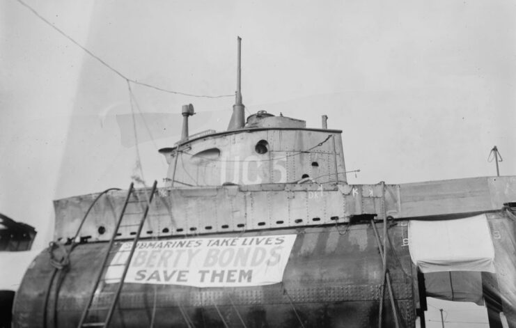 SM UC-5, with a sign that reads, "SUBMARINES TAKE LIVES / LIBERTY BONDS SAVE THEM"