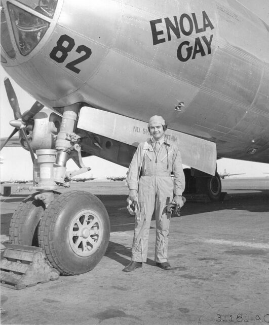 Paul Tibbets standing with the Boeing B-29 Superfortress 'Enola Gay'