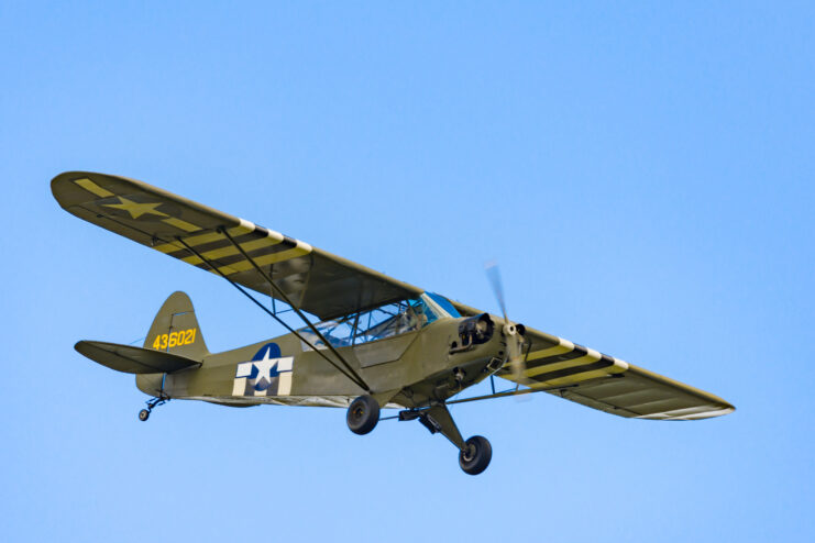 A Piper J-3 Cub in the sky.