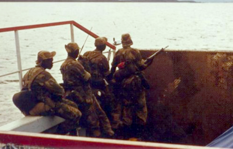 Four members of the Rhodesian African Rifles (RAR) sitting in a boat