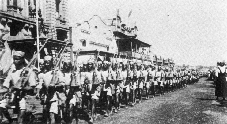 Members of the Rhodesian Native Regiment (RNR) marching with rifles