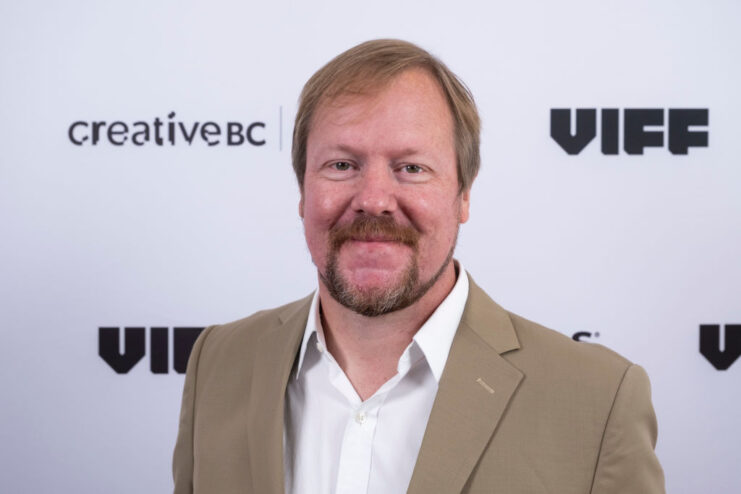 Steven Schwankert standing on a red carpet