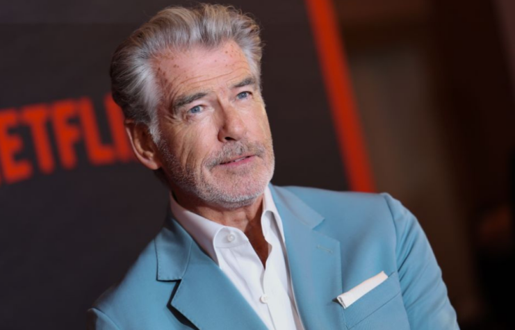 Pierce Brosnan standing on a red carpet