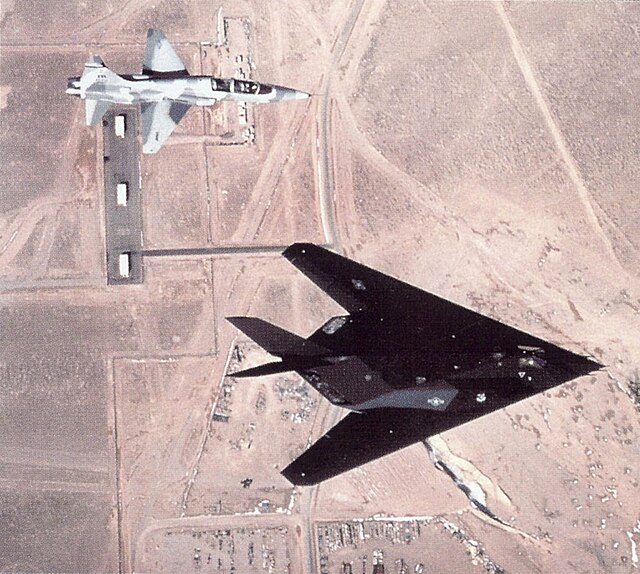 Lockheed F-117 Nighthawk and Northrop T-38 Talon flying over the airstrip at Tonopah Test Range (TTR)