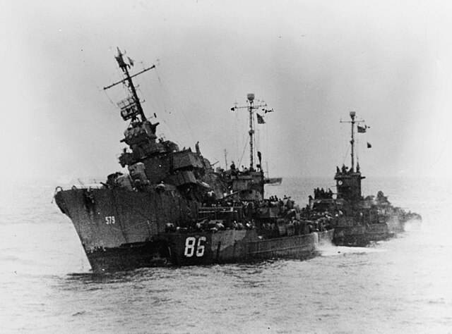 Two Landing Craft Support ships coming up behind the damaged USS William D. Porter (DD-579)