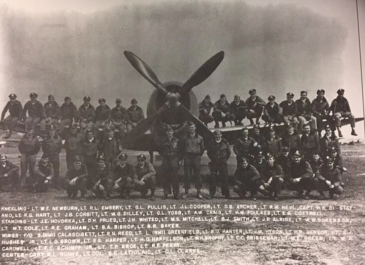 Members of the 493rd Fighter Squadron, 48th Fighter Group standing with an aircraft