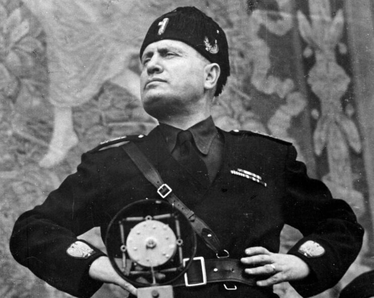 Benito Mussolini standing before a microphone