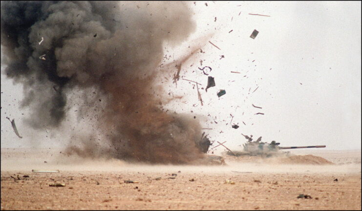 An Iraqi bunker blows up next to an Iraqi tank.