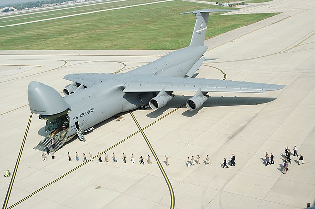 People lining up near a Lockheed C-5A Galaxy