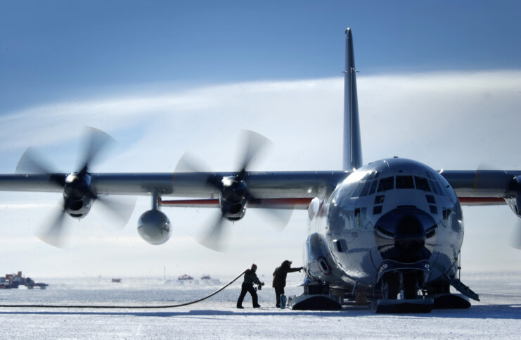 Personnel unloading cargo from a Lockheed LC-130 Hercules