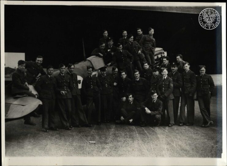 Members of the No 308 "Kraków" Polish Fighter Squadron standing in front of a Supermarine Spitfire