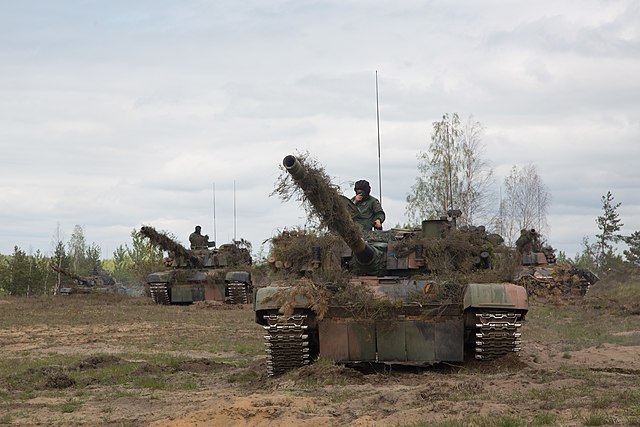 Polish soldiers manning PT-91 Twardy tanks