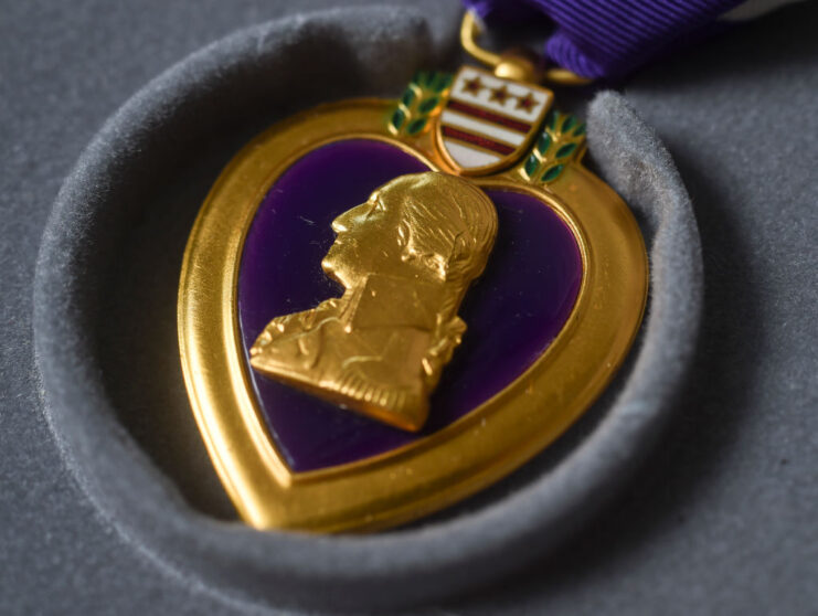 Close-up of a Purple Heart against a grey backdrop