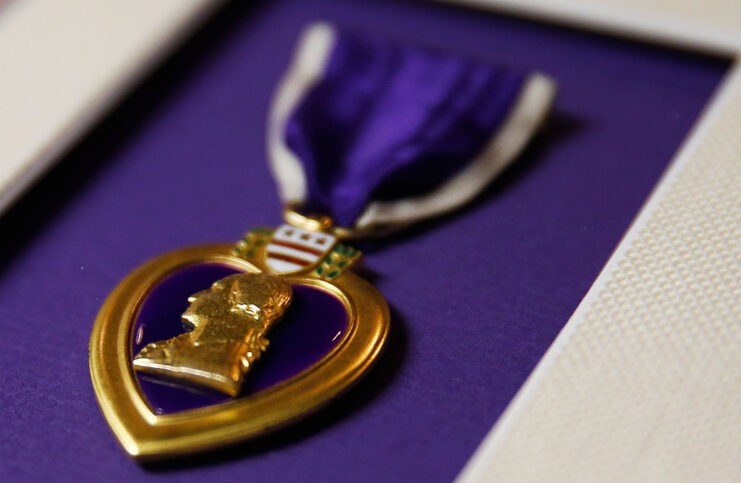 Close-up of a Purple Heart against a purple backdrop