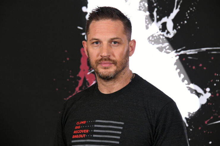 Tom Hardy standing on a red carpet