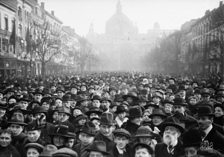 Crowd of Belgian citizens standing in the middle of a city street