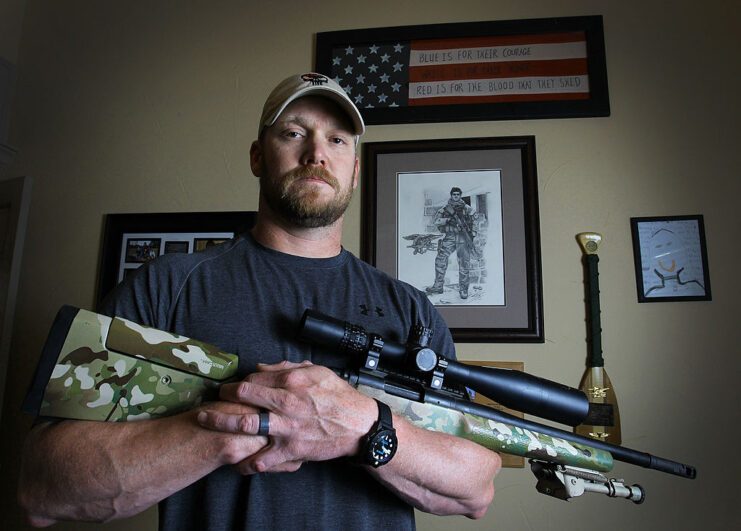 Chris Kyle holding a .308 sniper rifle