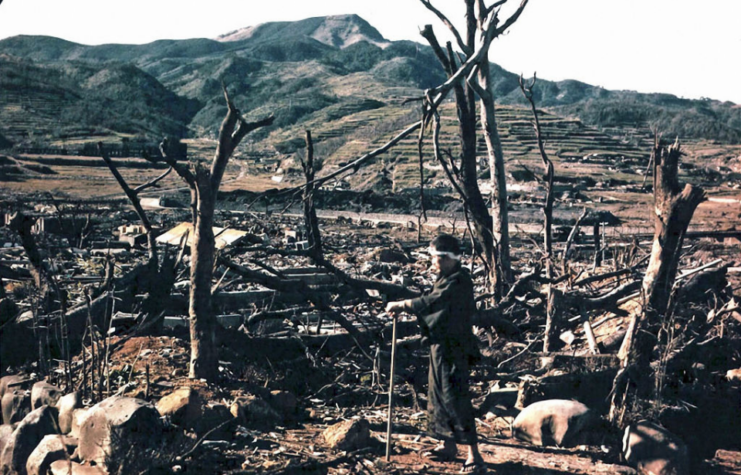 Takashi Nagai standing amid the ruins of Nagasaki