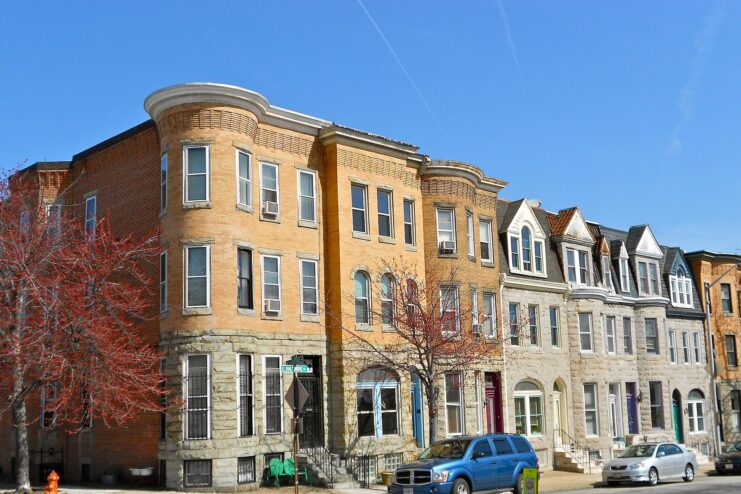 Cars parked along the side of a street, with residences lining the road