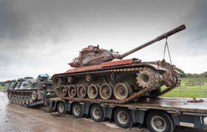 M47 Patton being loaded onto the back of a flatbed truck