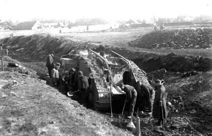 German soldiers standing around a Mark IV tank in a trench