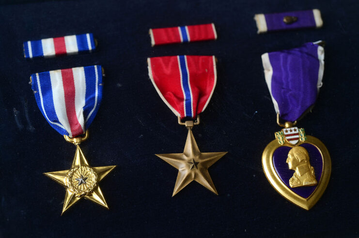 Silver Star, Bronze Star and Purple Heart against a black backdrop