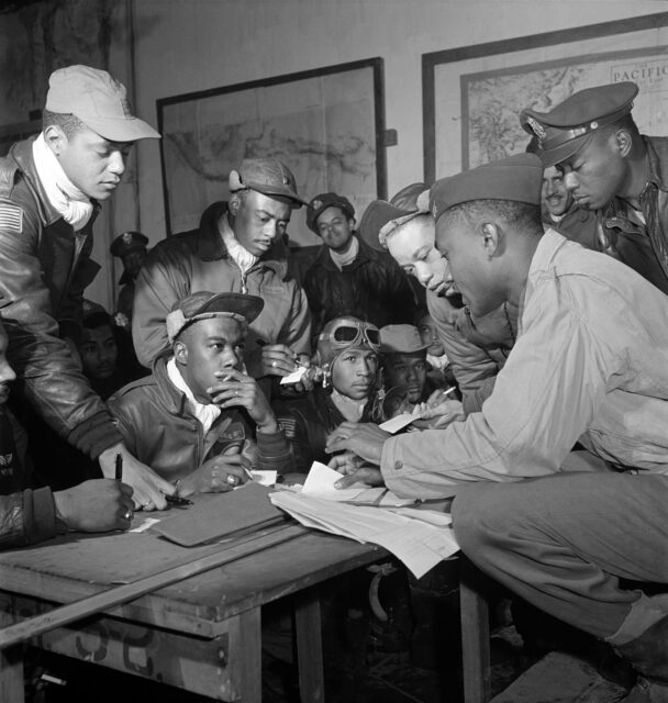 Tuskegee Airmen gathered around a table