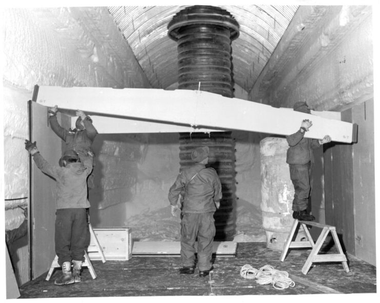 Group of men installing a truss at Camp Century