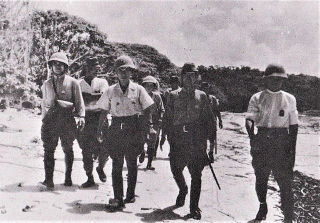 Soldiers with the Imperial Japanese Army's (IJA) 15th Infantry Regiment standing on a beach