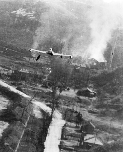 Lockheed F-80 Shooting Star dropping a napalm bomb mid-flight