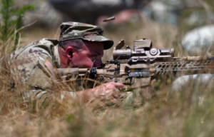 Sgt. 1st Class Robert Martin aiming an XM7