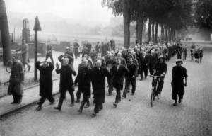 Dutch collaborators being marched down a street