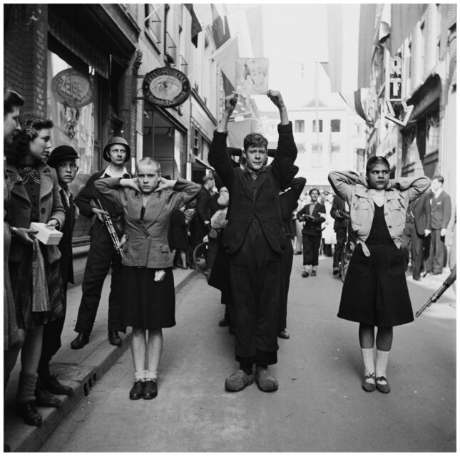 Dutch citizens who collaborated with the Germans standing in the middle of a city street