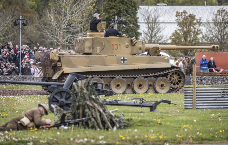 Crowd watching Tiger 131 drive around a dirt track