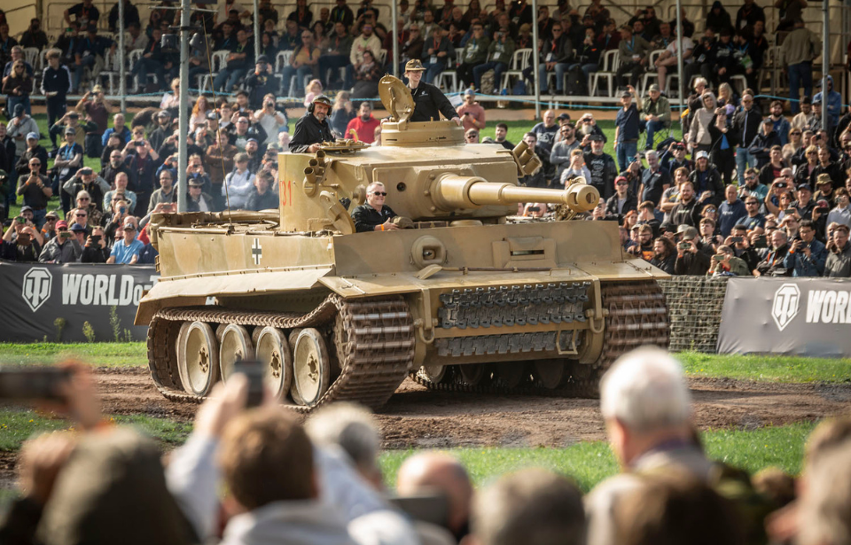 Crowd watching Tiger 131 drive around a dirt track