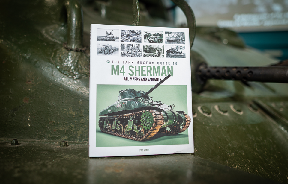 A copy of 'The Tank Museum Guide to the M4 Sherman Medium Tank' placed atop an M4 Sherman