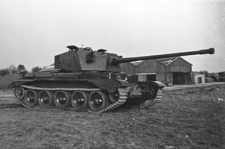 Charioteer parked on grass, near buildings