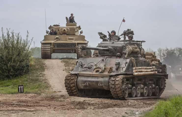 Sherman M4A2E8 'Fury' and Tiger 131 driving along a dirt track